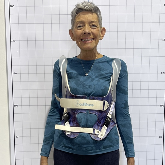 A woman wearing a KyphoBrace.